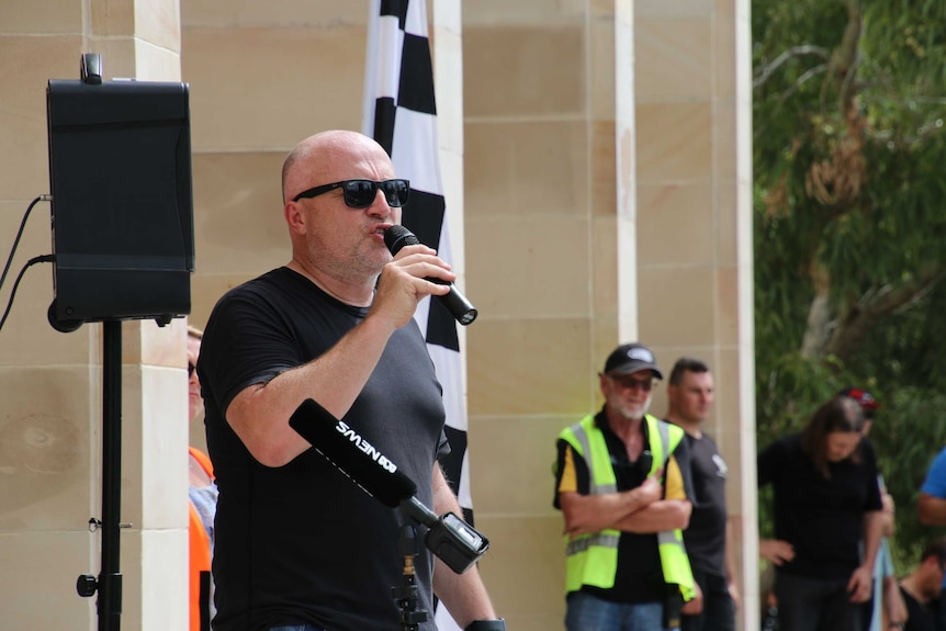 Rally speaker Carlo Bertozzi addresses the crowd on the steps of Parliament House.