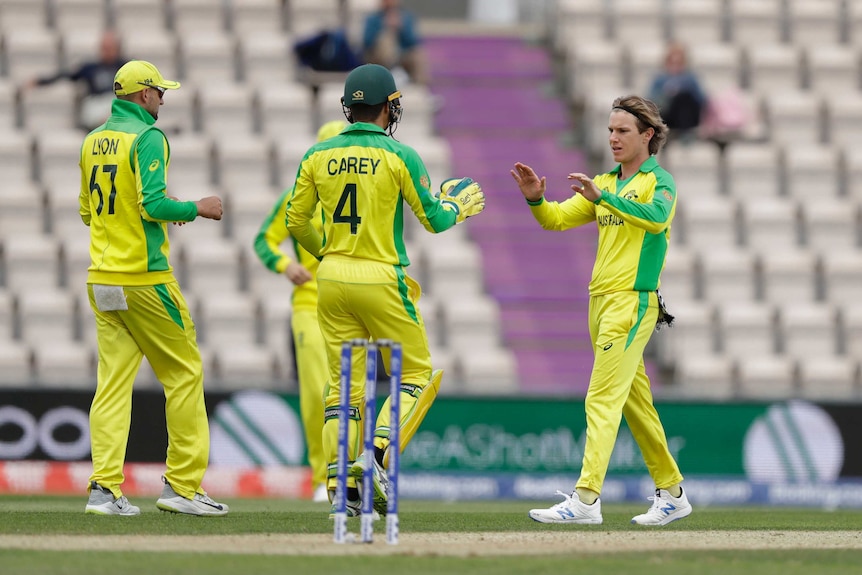 A bowler celebrates with a wicket-keeper after taking a wicket in a one-day practice match.