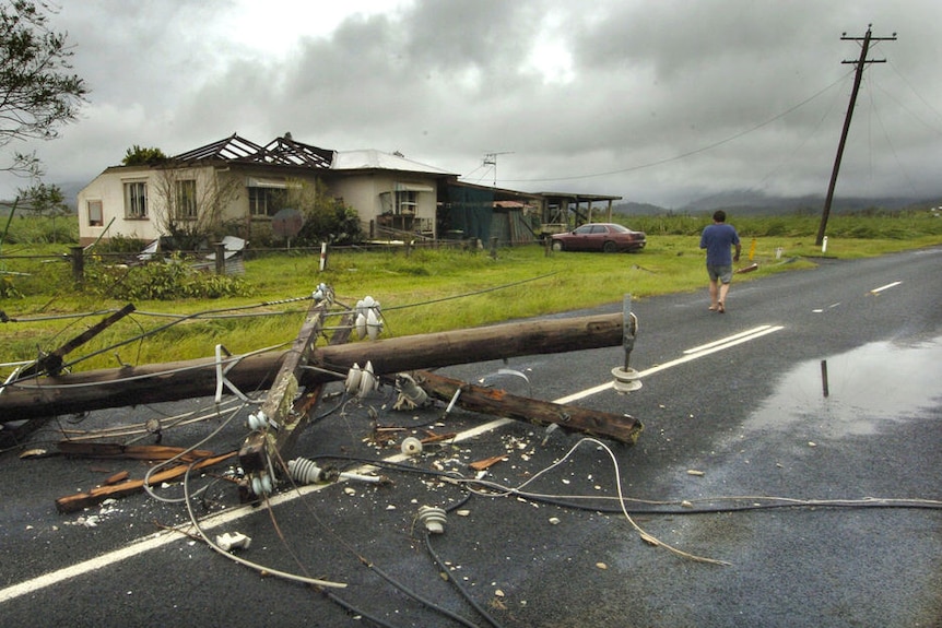Ray Ladlow walks to his destroyed home in Silkwood, south of Innisfail on March 21, 2006.