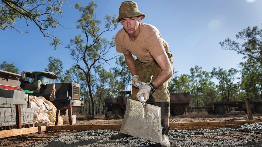 Corporal Jason Neumann helps lay concrete with the Army Aboriginal Community Assistance Program in far north Queensland.