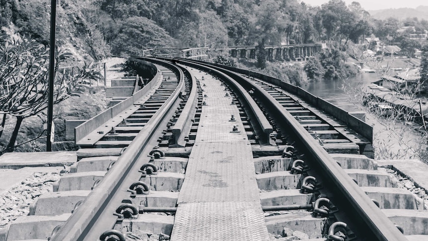 A black and white photo of a railway line