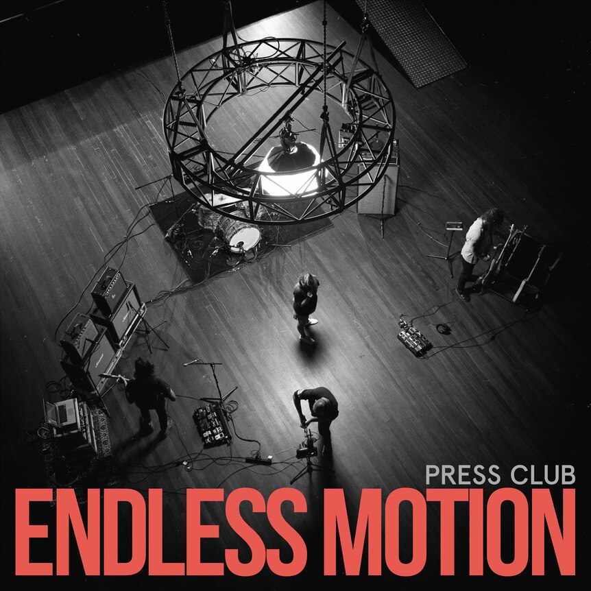blackj and white aerial photo of the band press club performing in a big studio
