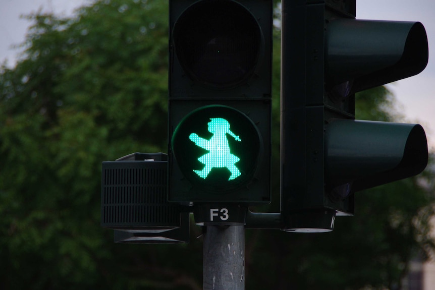 A female pedestrian crossing in Germany.