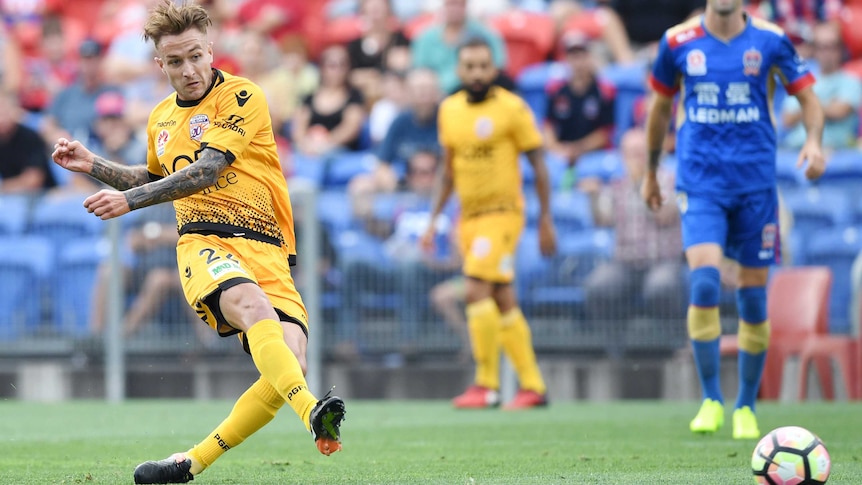 Adam Taggart (L) scores for Perth Glory against Newcastle Jets in Newcastle on January 15, 2017.