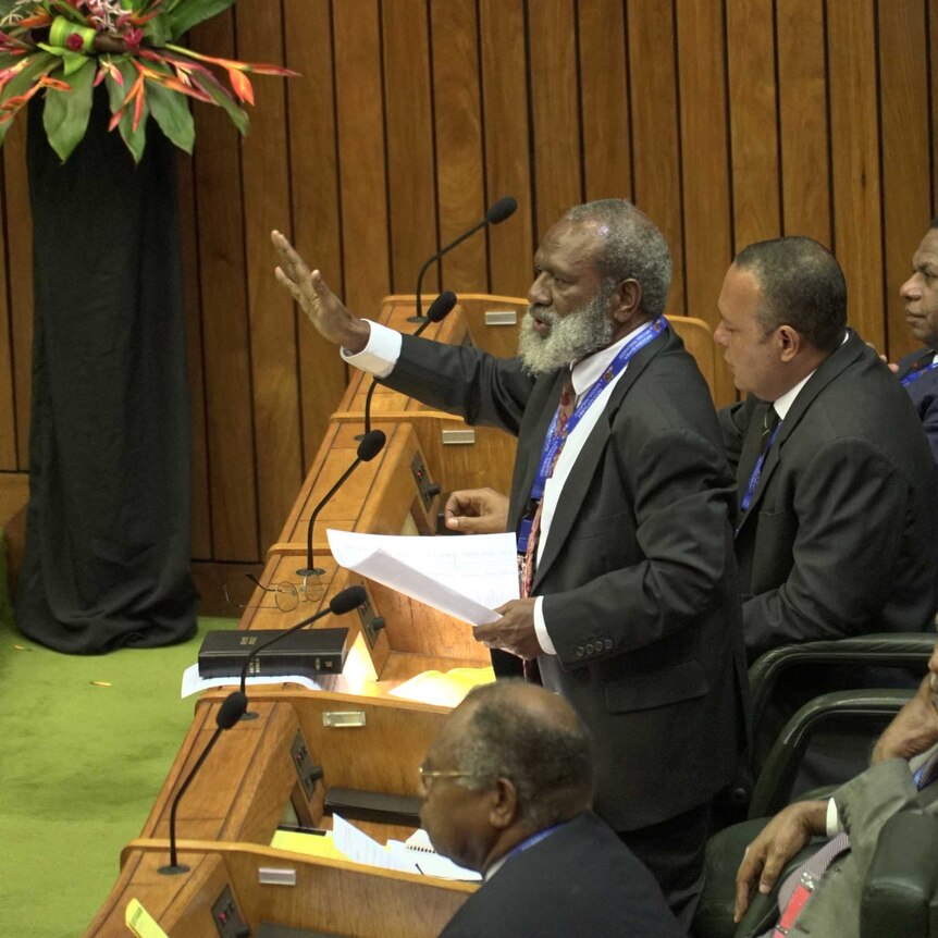 Opposition MP Kerenga Kua raises his hand and demands the Clerk of Parliament eject six members supporting Peter O’Neill.