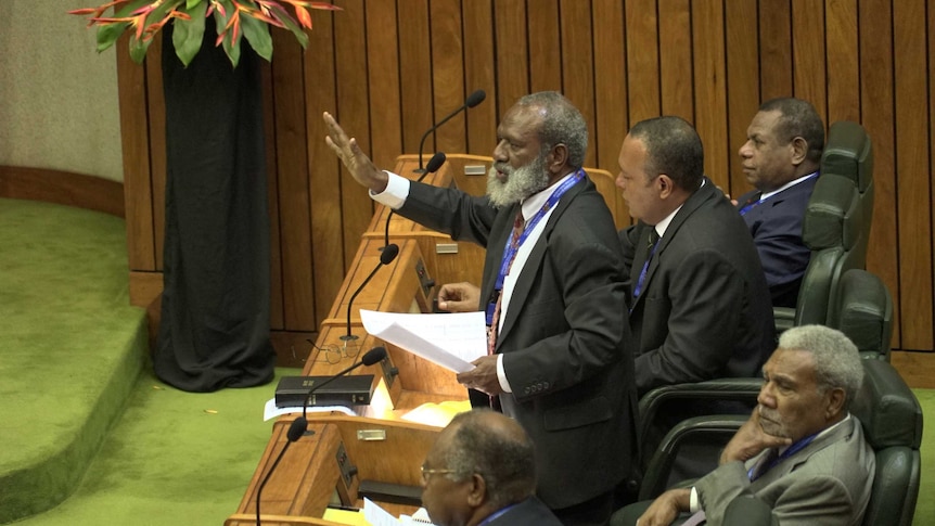 Opposition MP Kerenga Kua raises his hand and demands the Clerk of Parliament eject six members supporting Peter O’Neill.