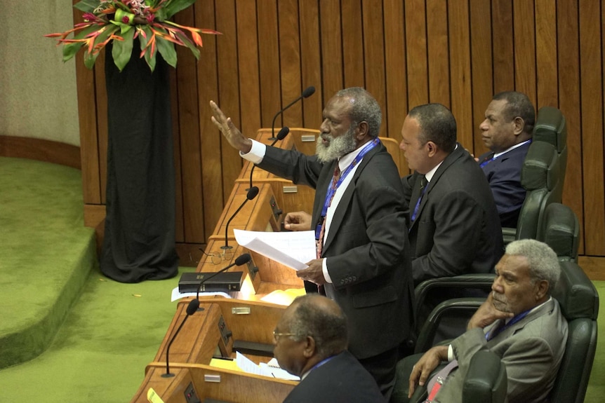 Opposition MP Kerenga Kua raises his hand and demands the Clerk of Parliament eject six members supporting Peter O’Neill.