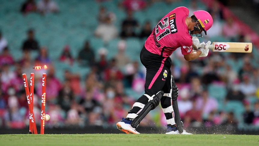 A Sydney Sixers BBL player is bowled during a match in the 2021/22 season.
