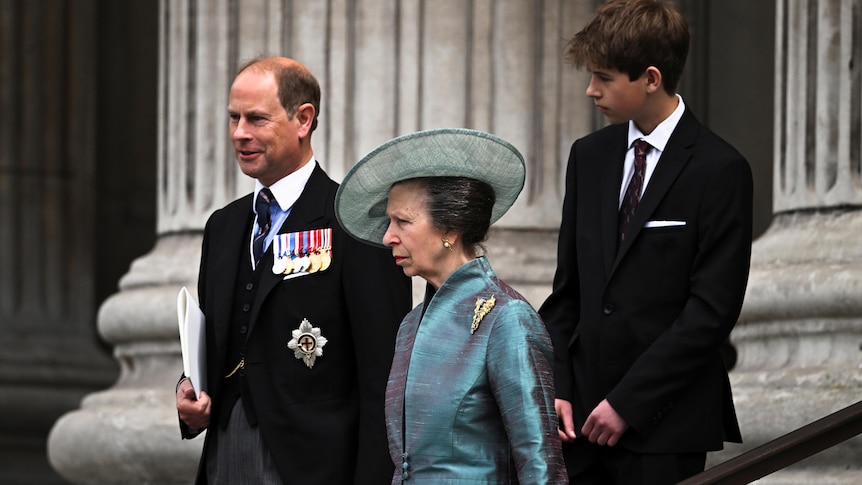 princess anne in a blue suit and large hat, and princess edward ina  suit, with a young boy also in a suit