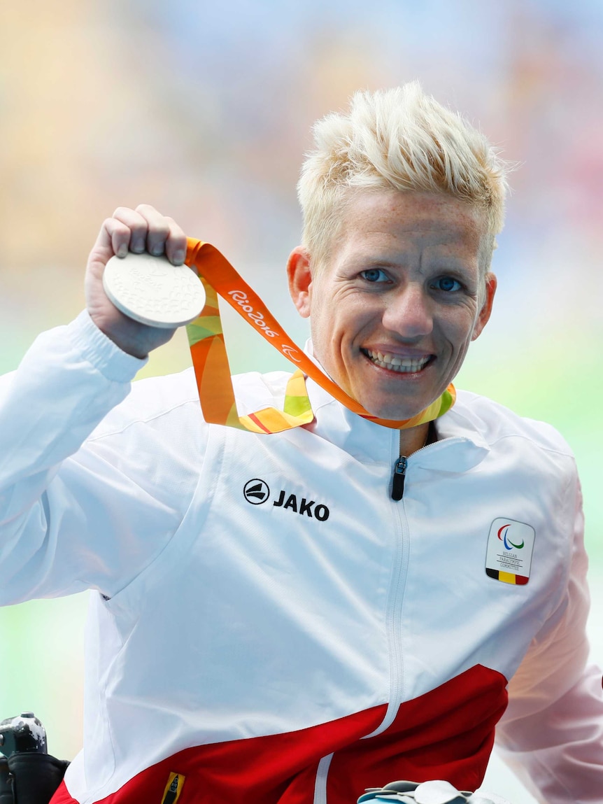 Vervoort smiles as she holds up a silver medal.