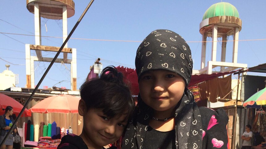 Two smiling girls in Turpan