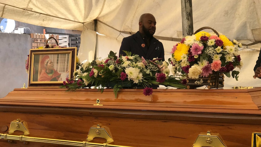 A photograph and flowers adorn Lucia Mazibuko's coffin at her funeral.