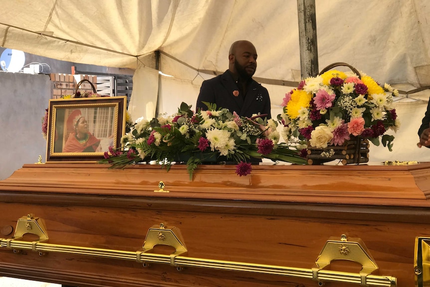 A photograph and flowers adorn Lucia Mazibuko's coffin at her funeral.