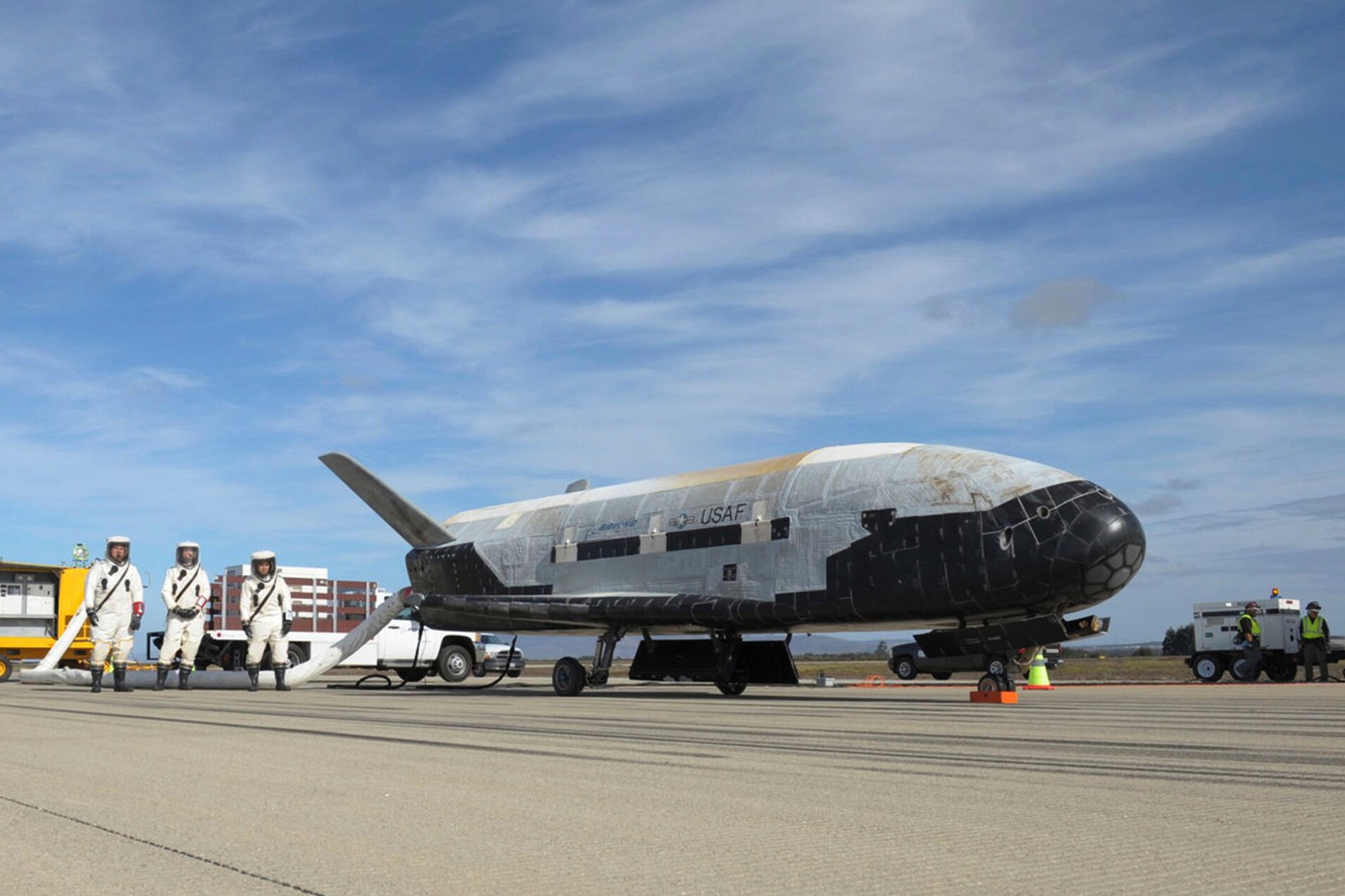 a picture of the space plane on a run way with space crew 