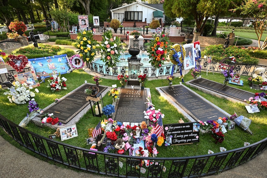 The graves of Elvis Presley, his mother Gladys, his father Vernon and his grandmother Minnie Mae, with many flowers and tributes