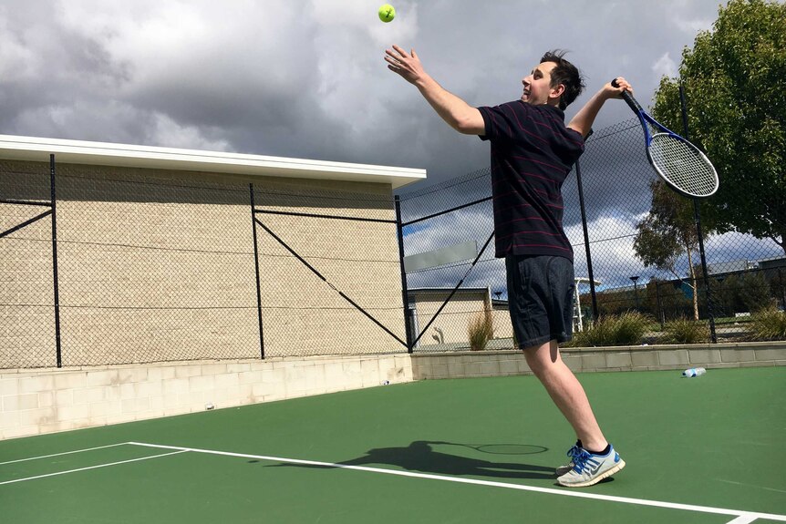 ACT Labor MLA Michael Petterson playing tennis.