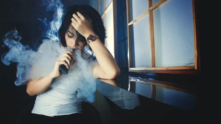 A woman vaping.