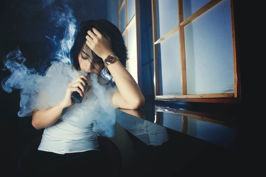 A woman vaping.