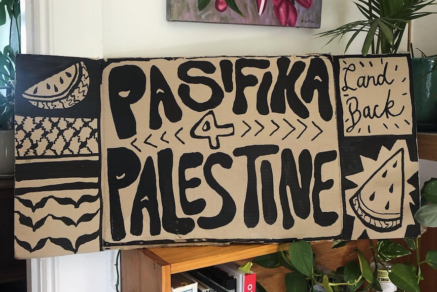 A hand painted sign with the words 'Pasifika 4 Palestine'. 
