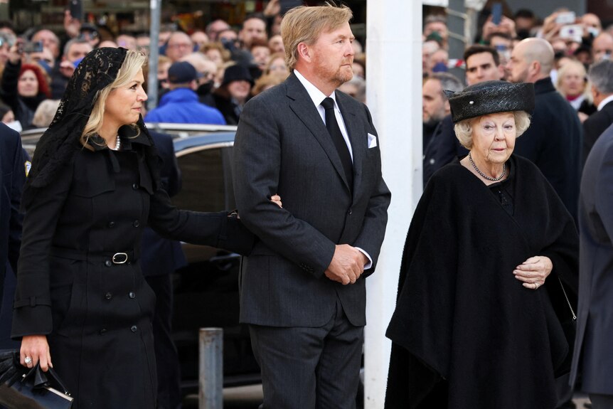 The King of the Netherlands is pictured arriving at the funeral with Queen Maxima and the former Queen Beatrix.