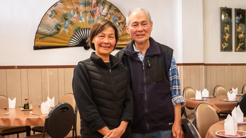 A middle-aged Chinese couple inside their family Chinese restaurant