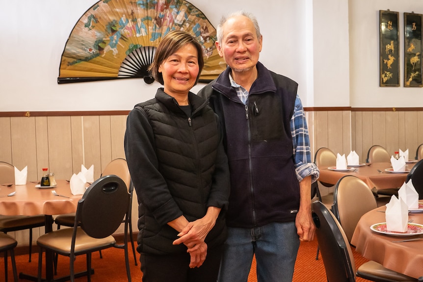 A middle-aged Chinese couple inside their family Chinese restaurant