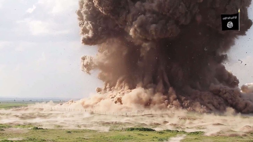 A cloud of dust following Nimrud being blown up by Islamic State