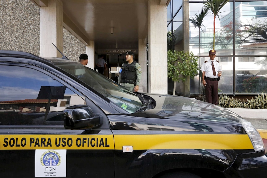 Police officers stand next to car parked outside the Mossack Fonseca law firm office in Panama City.