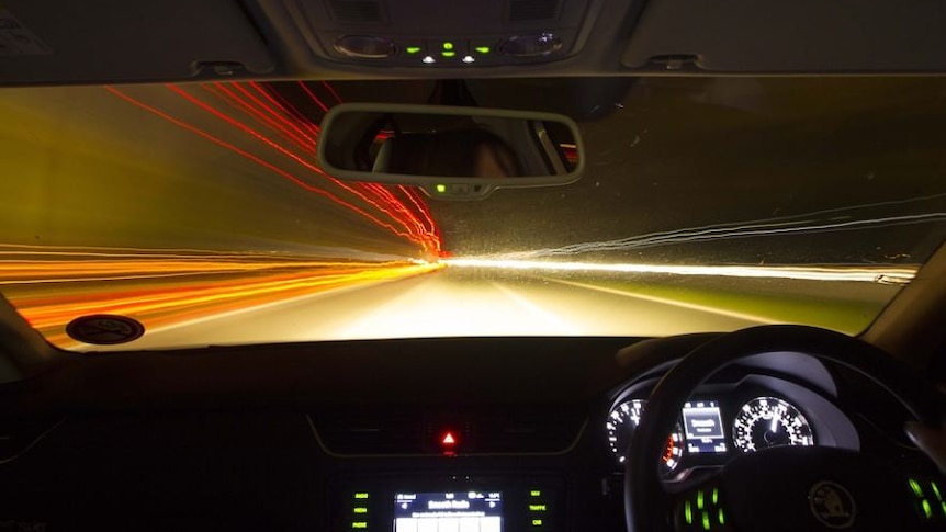 Picture of a brightly lit tunnel at night 