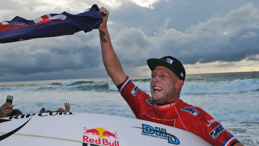 Australia's Mick Fanning celebrates after winning the world surfing tour event in France.
