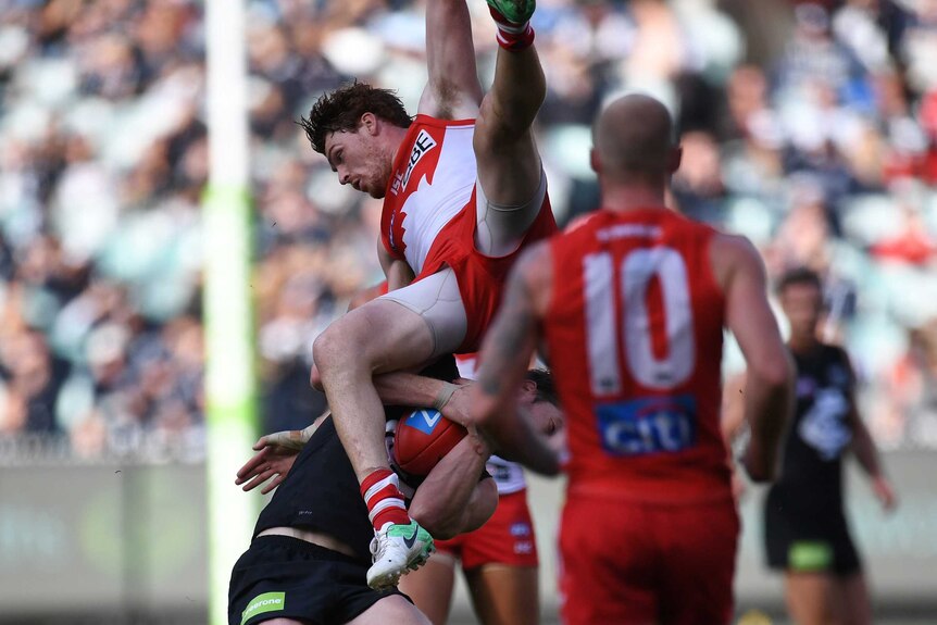 Gary Rohan falls after skying for a mark against Carlton