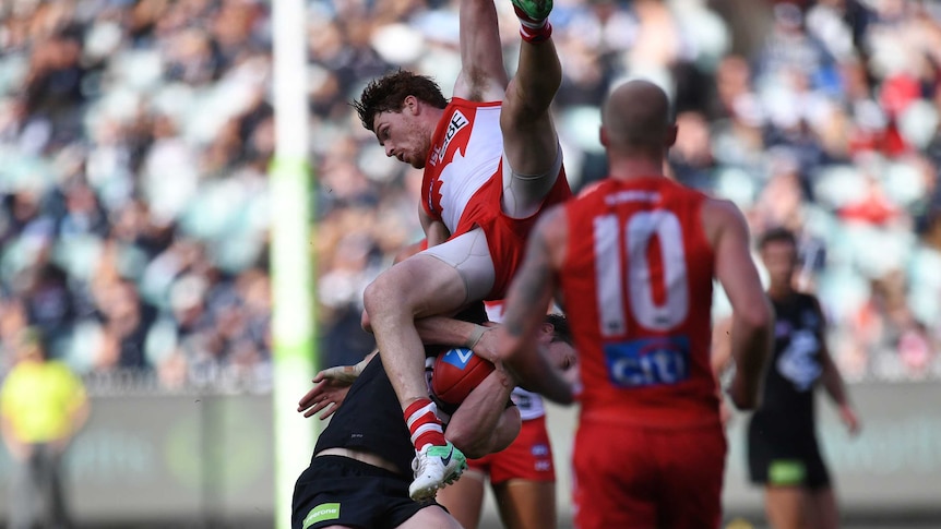 Gary Rohan falls after skying for a mark against Carlton