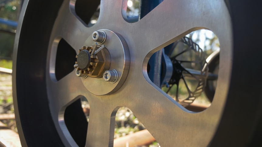 Close-up shot of an aluminium wheel designed to travel on a railway.