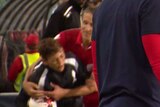 Video still of young boy being knocked to the ground by an Adelaide United player.