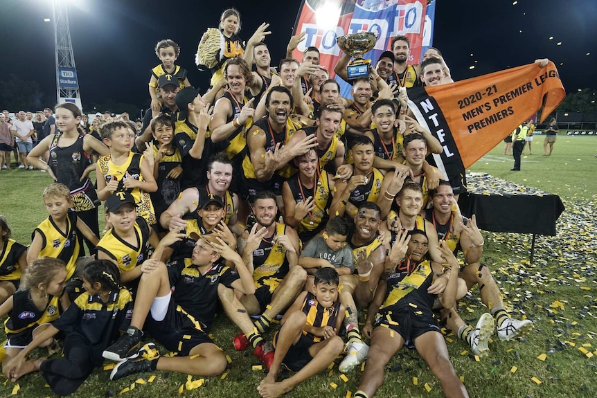 Nightcliff Tigers celebrate with the premiership cup after winning the 2020/21 NTFL grand final.