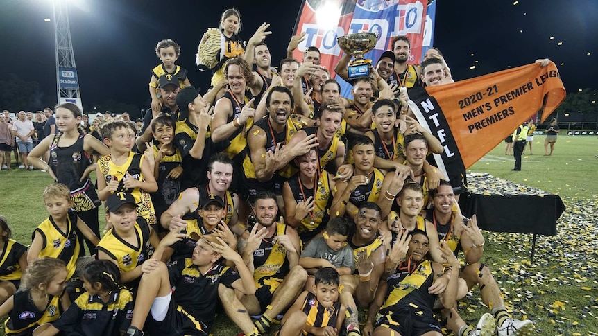 Nightcliff Tigers celebrate with the premiership cup after winning the 2020/21 NTFL grand final.