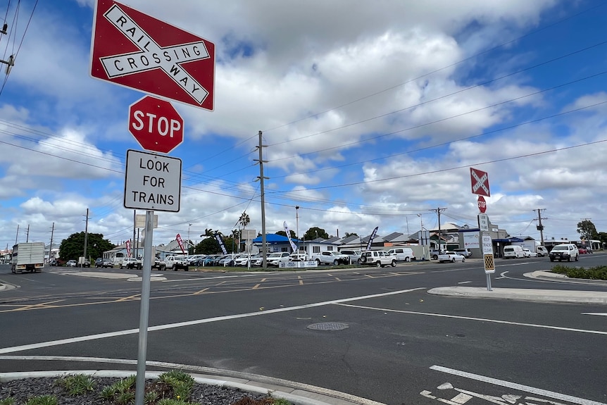 Photo of a rail stop sign in front of a intersection