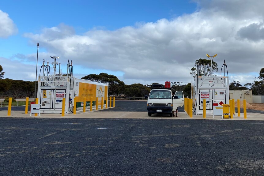 White van refuelling at new refueling station featuring two large square tanks and pumps on bitumised service