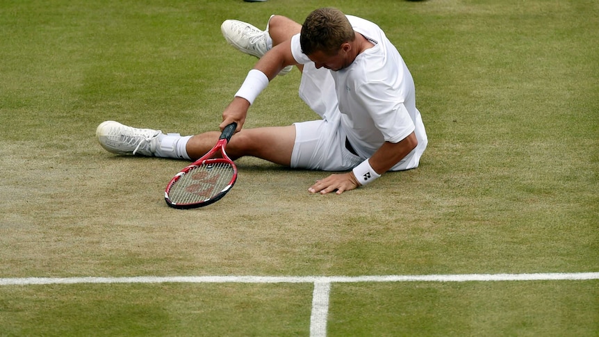 Australia's Lleyton Hewitt takes a fall in his match against Jerzy Janowicz at Wimbledon.