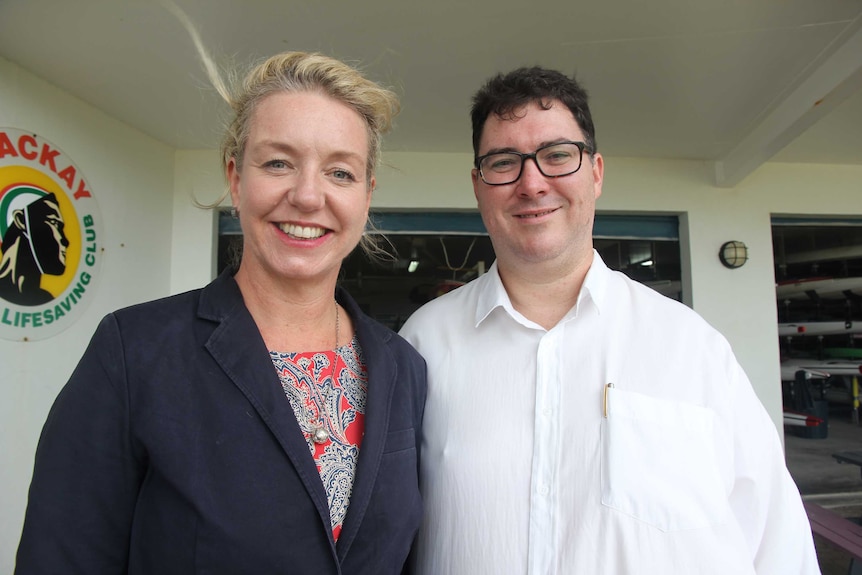 A woman and a man smile at the camera