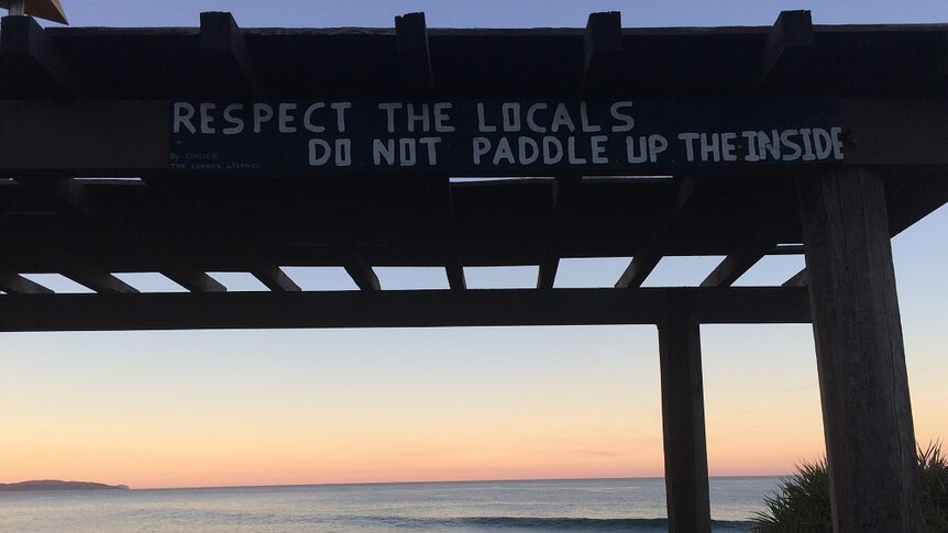A sign imploring visitors to the Lennox Head point surf break to 'respect the locals, do not paddle up the inside'.