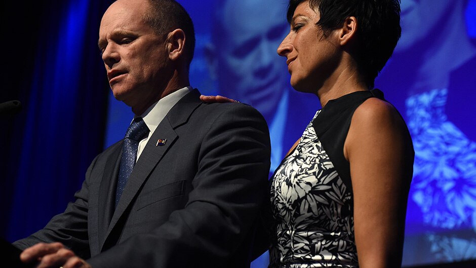 Queensland Premier Campbell Newman, flanked by his wife Lisa, concedes defeat in the state election in Brisbane.