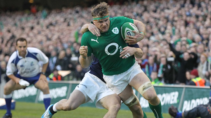 On the charge ... Ireland number eight Jamie Heaslip breaks free from a tackle by Max Evans