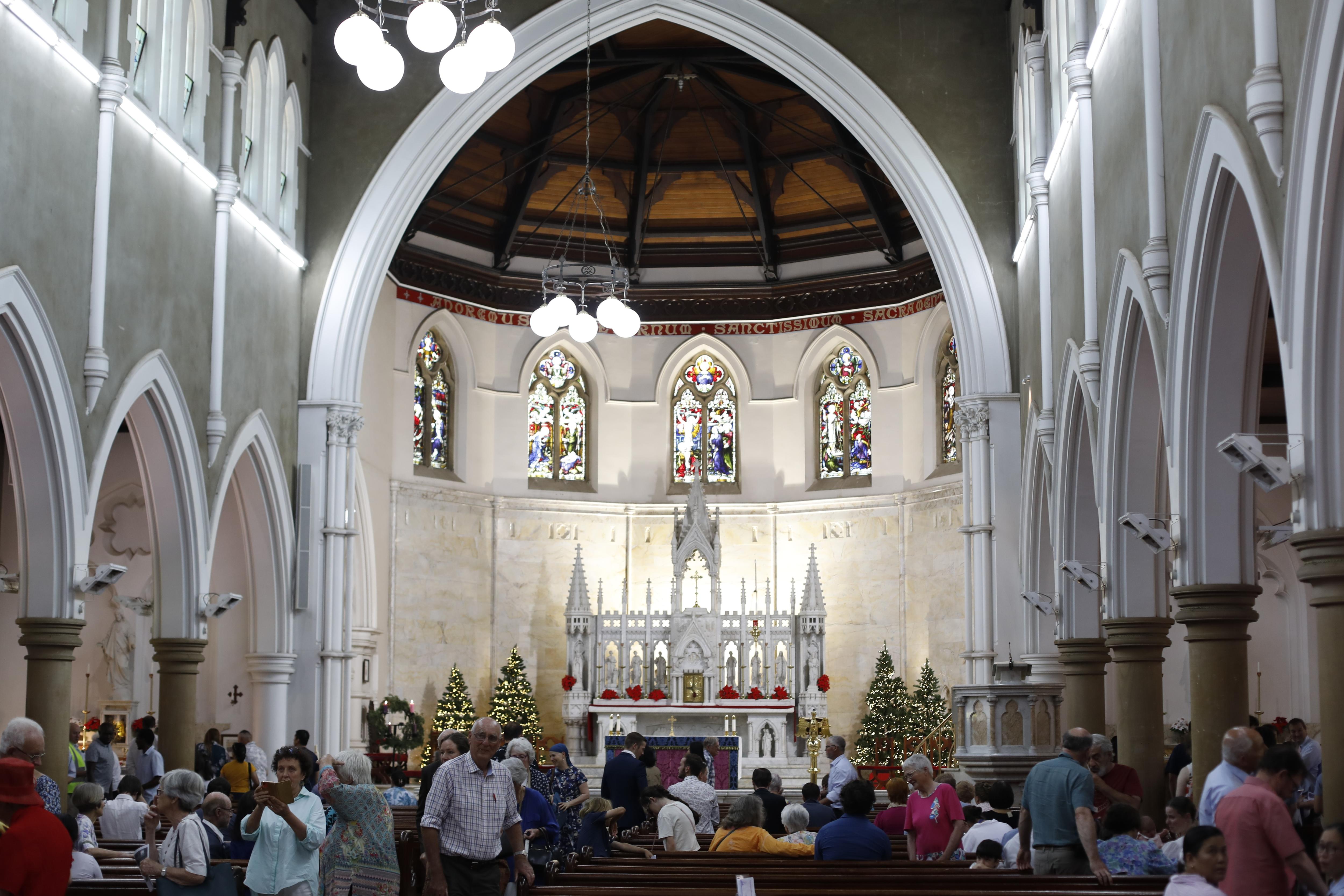 Parishioners inside a Catholic cathedral after mass. 