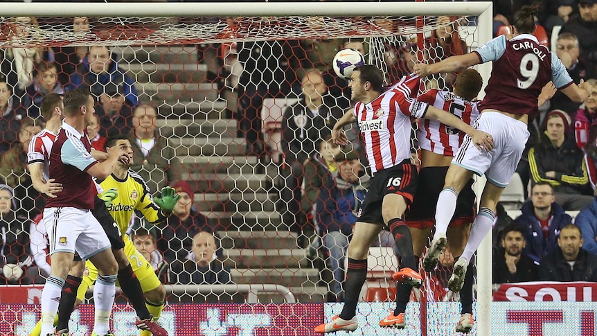 West Ham striker Andy Carroll (R) scores the opening goal against Sunderland.