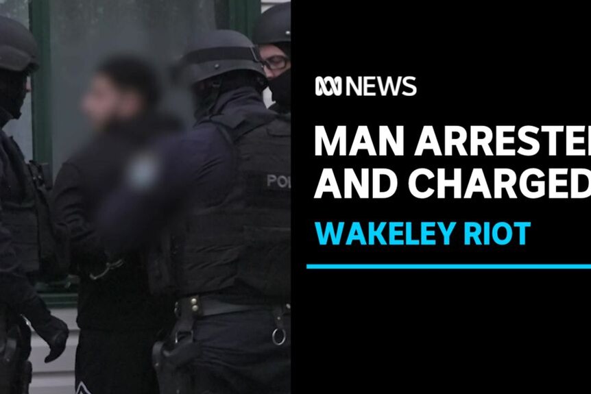 Man Arrested and Charged, Wakeley Riot: Tactical police officers apprehending a man with a blurred face.