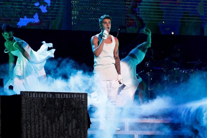 Justin Bieber performs on a stage during his world tour concert in Beijing in 2013.