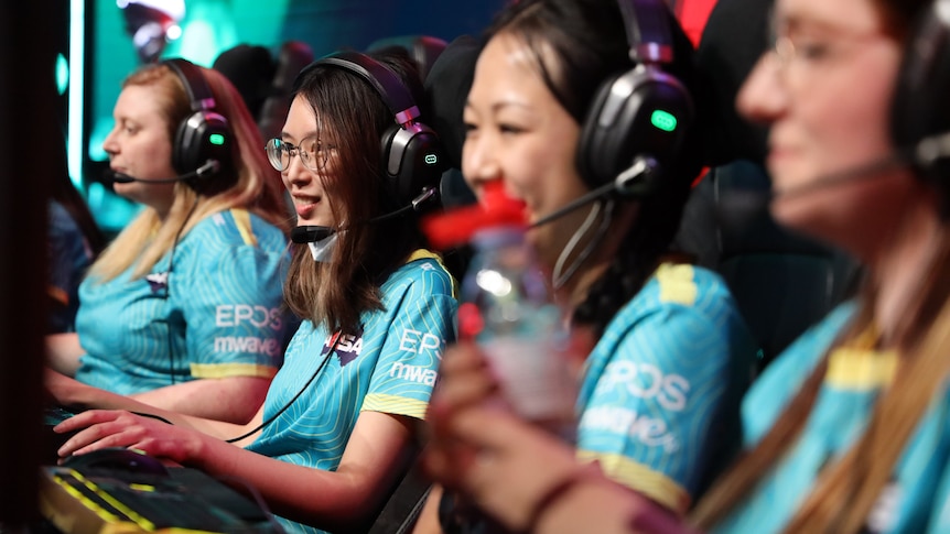 Women wear headsets while playing competitive esports.