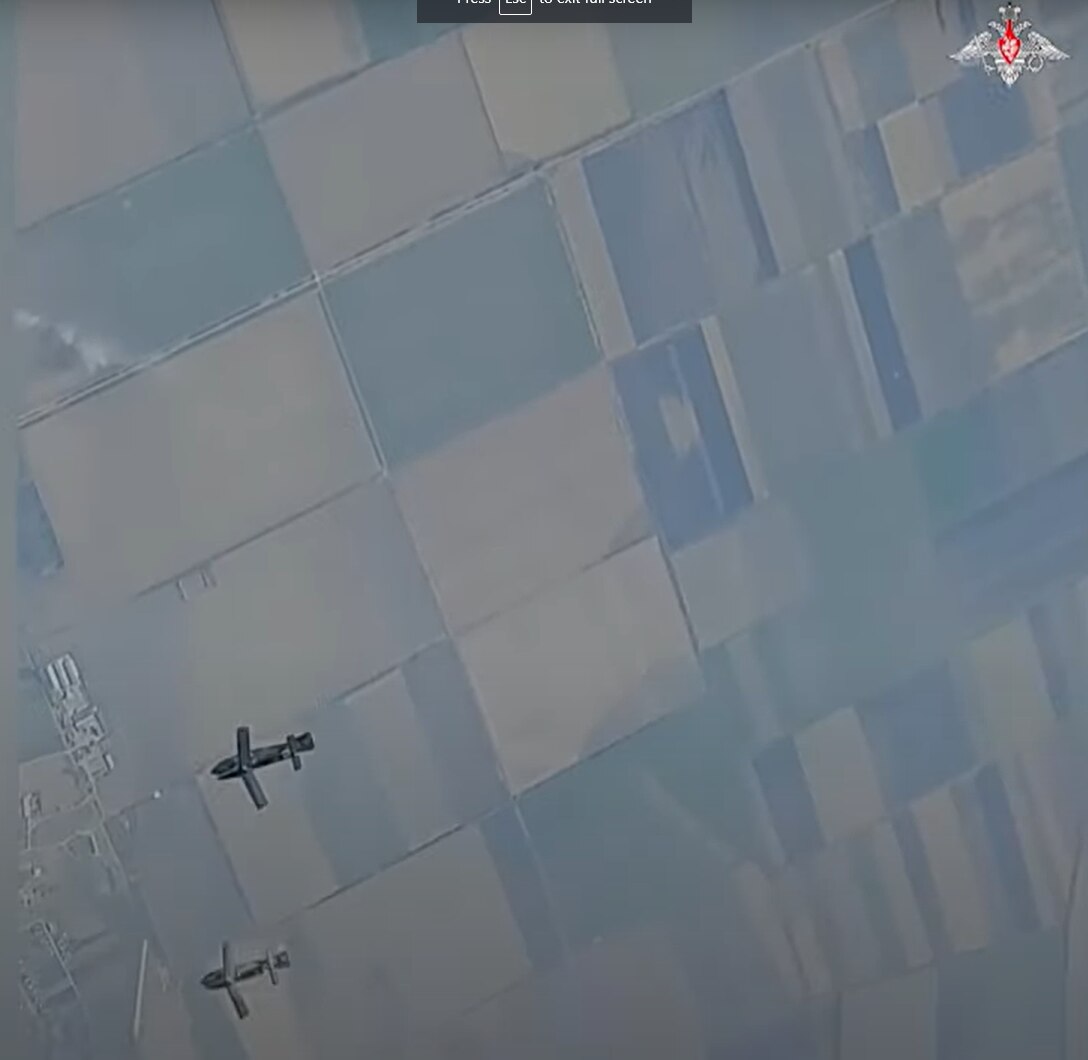 Aerial view of glide bombs soaring in the sky after being dropped from a fighter jet.