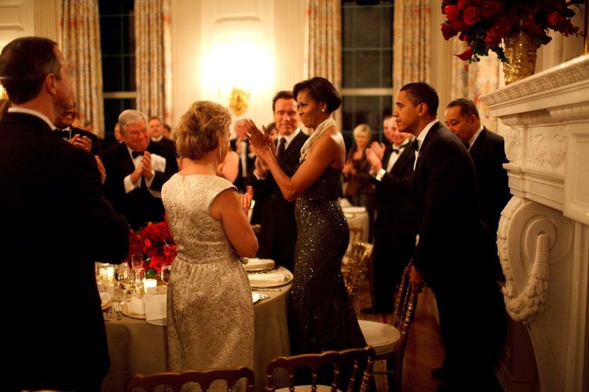 President Barack Obama pulls out the chair for First Lady Michelle Obama at the Governors Ball